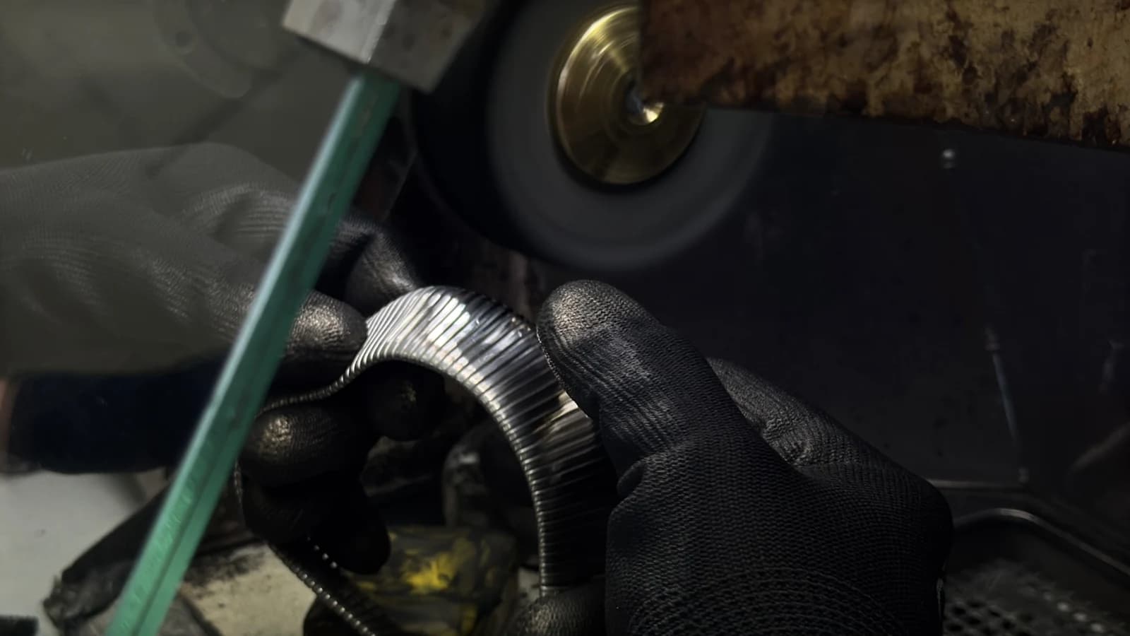 Gloved hands working tubogas in the RUDY workshop